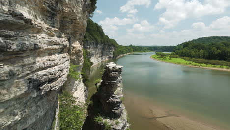 cliffs by beaver lake in arkansas on a sunny day with lush greenery and calm waters