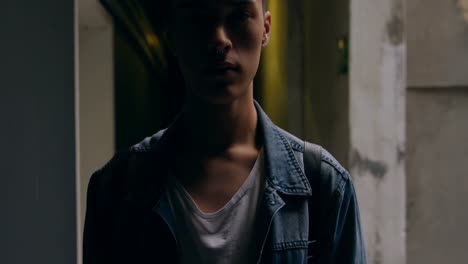 young man standing in corridor 4k