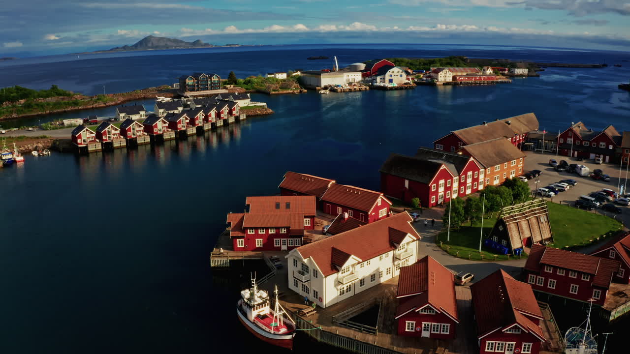Aerial drone shot over Svolvaer, Lofoten Islands, Norway.
High view of the fishermen cabins and the scenic nordic landscape at sunset.
