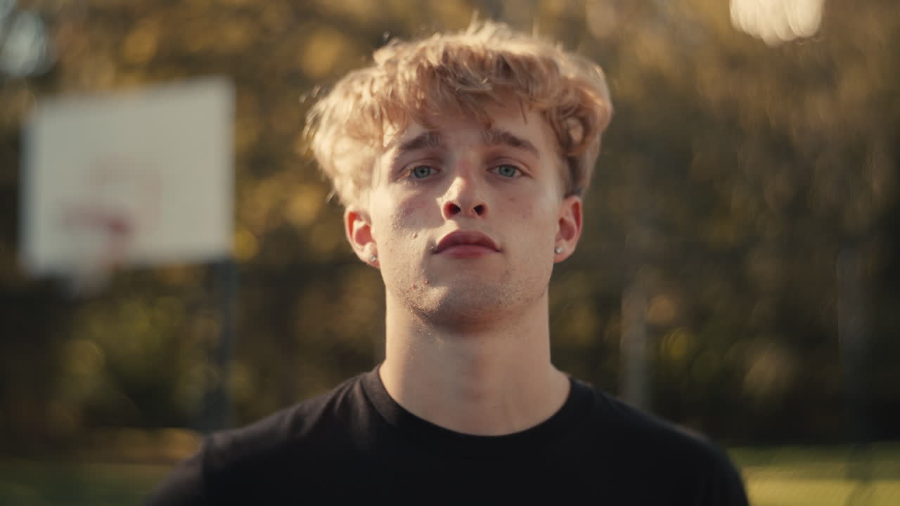 Portrait of a young man at a basketball court