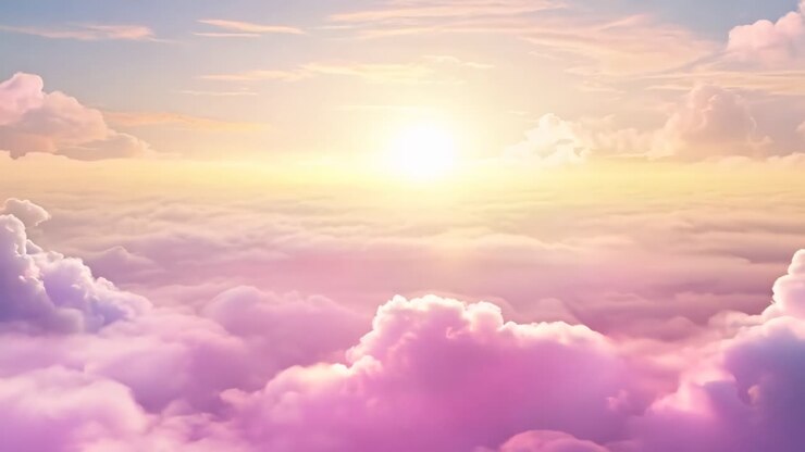 Aerial view of a vibrant sunset above fluffy clouds, creating a dreamy, ethereal atmosphere