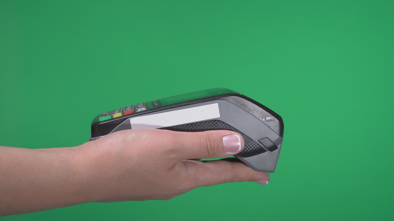Close up female hold in hand wireless modern bank payment terminal to process acquire credit card payments black card isolated on green screen. Copy space mock up advertising, man pay