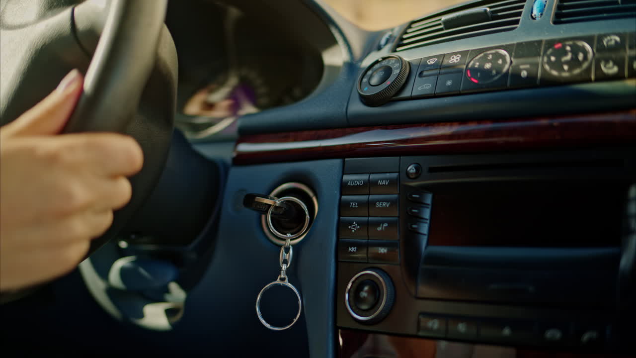 Person rotating the steering wheel while driving a car