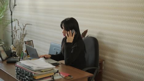 professional woman in a modern office environment, focused on work, dressed elegantly in business attire, surrounded by office equipment and a sleek interior