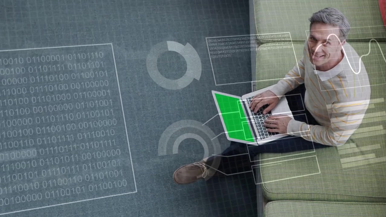 Man typing on laptop on sofa, generating binary block and charts linking screen for technology demo