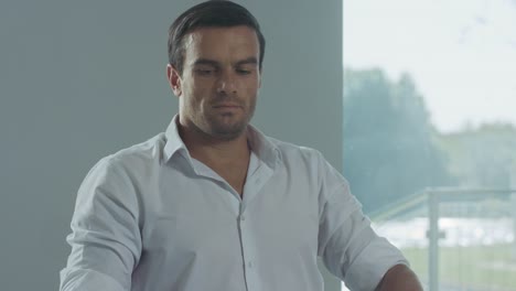 Business-man-finishing-working-day.-Closeup-portrait-of-male-drinking-coffee.