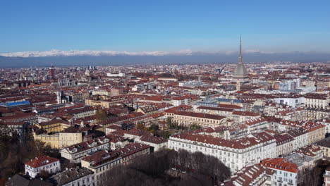 aerial pull-out of turin (torino) city centre with mountains in the background