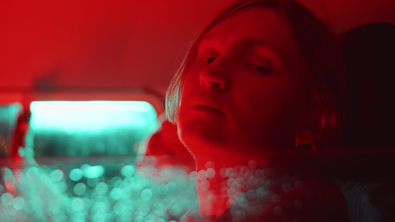 Portrait of Young Man in Car with Red Light