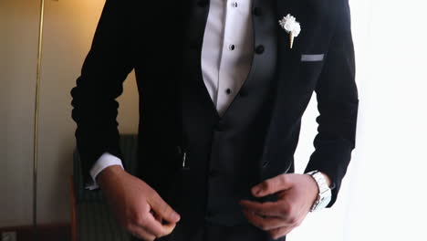 a man wearing the suit for his wadding - close up - fixed camera