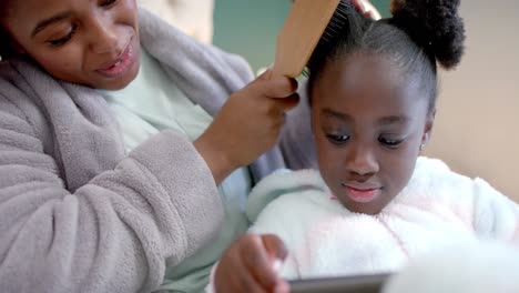 Montage-of-african-american-mother-and-daughter-relaxing-and-cooking-at-home,-slow-motion