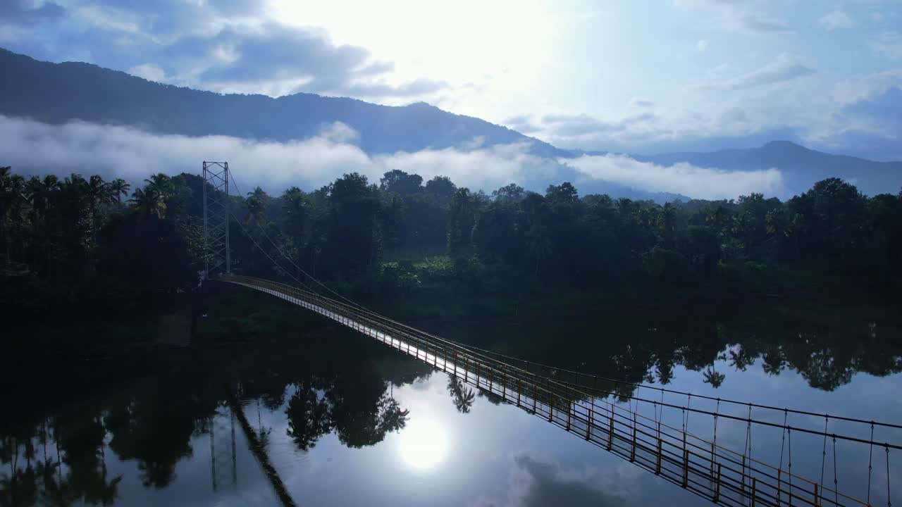 God's own country Kerala river moving to a hanging bridge with misty morning river