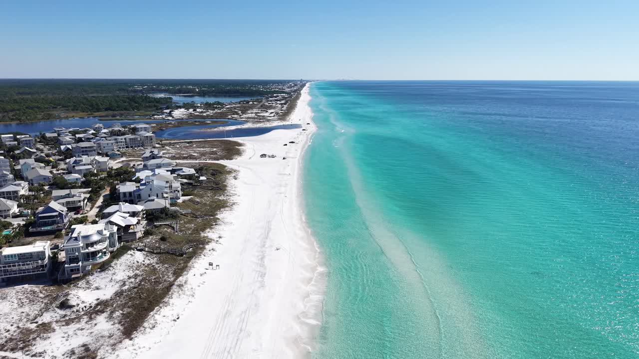 Backward panning drone fly at long coastline of Grayton Beach inhabited area, 30A, Florida, USA
