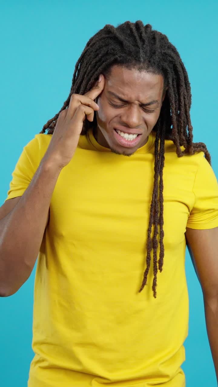 Man with dreadlocks suffering from headache