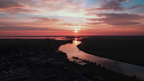 ferry passing and busy water traffic in the sunset on the small dutch river