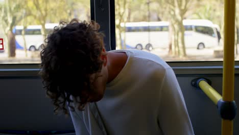 male commuter using mobile phone while travelling in bus 4k