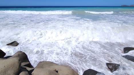 White-waves-splashing-on-rocky-beach,-beautiful-panoramic-sea-scape-with-blue-turquoise-water-on-shoreline-of-Mediterranean-sea