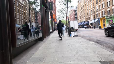 pedestrians walking along a bustling city street