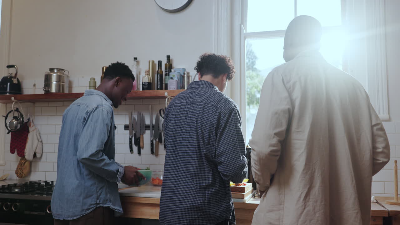 Three men cooking in a kitchen