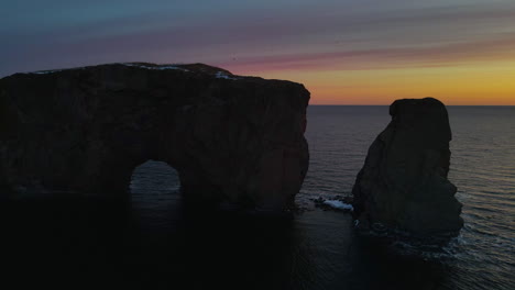 drone view at sunrise of famous perce rock in percé, québec, canada
