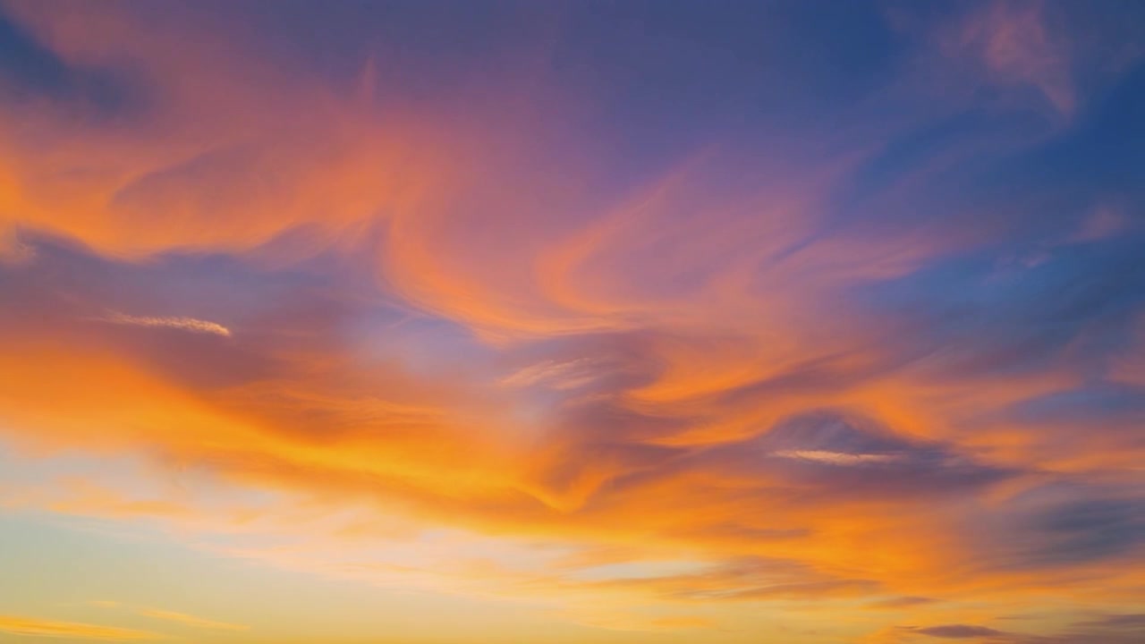 Vibrant Sunset Sky with Swirling Golden Clouds