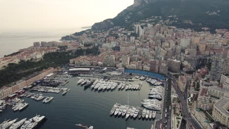 yacht boats in port harbor on monaco city coast, aerial drone view