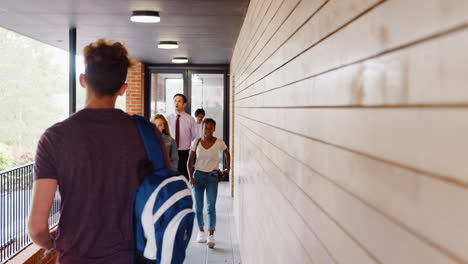 Teenage-Students-And-Teacher-Walking-Between-School-Buildings