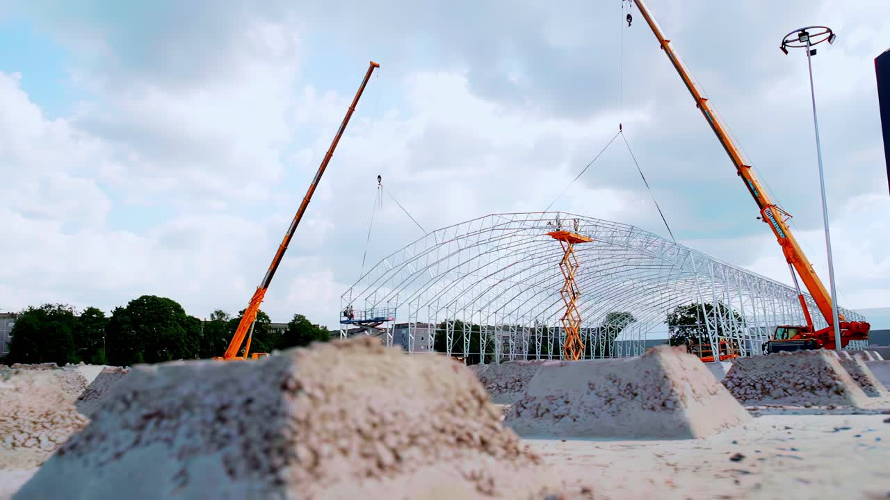 Workplace industrial warehouse building site metal frame under construction crane heavy machinery
