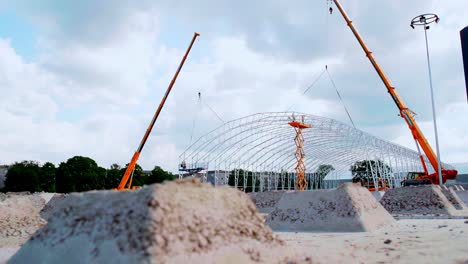 workplace industrial warehouse building site metal frame under construction crane heavy machinery