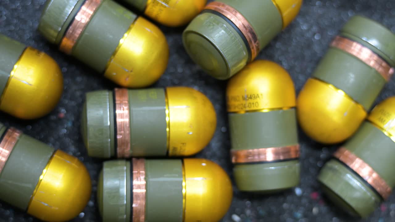 Grenades seen from overhead, to be modified with plastic casings for drone deployment at a workshop in Ukraine's Donetsk region. Modern warfare tech.
