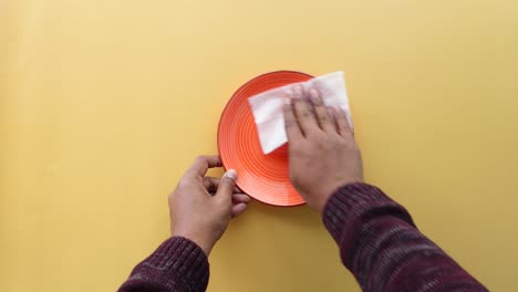 person cleaning a plate