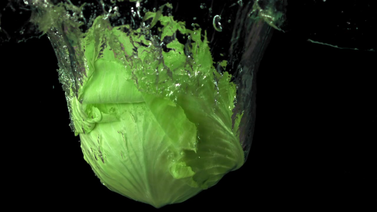 Green Cabbage Dropping into Water in Slow Motion