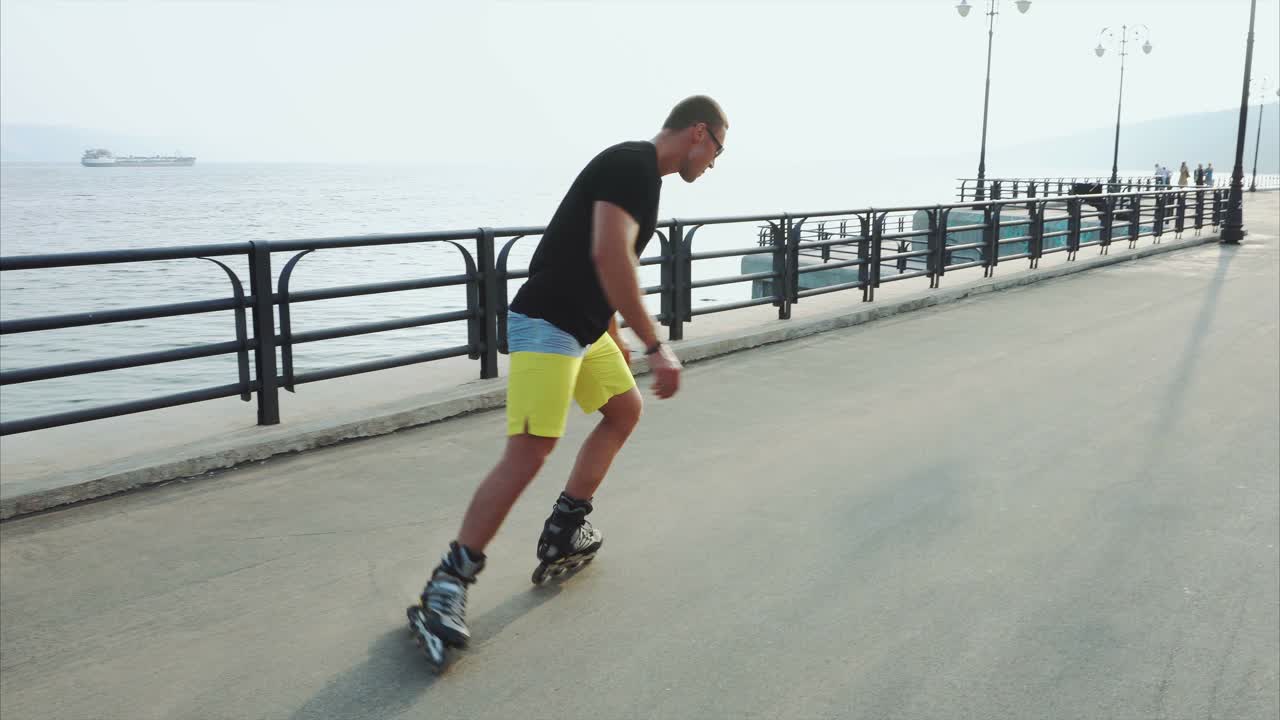 Man Roller Skating on Coastal Road