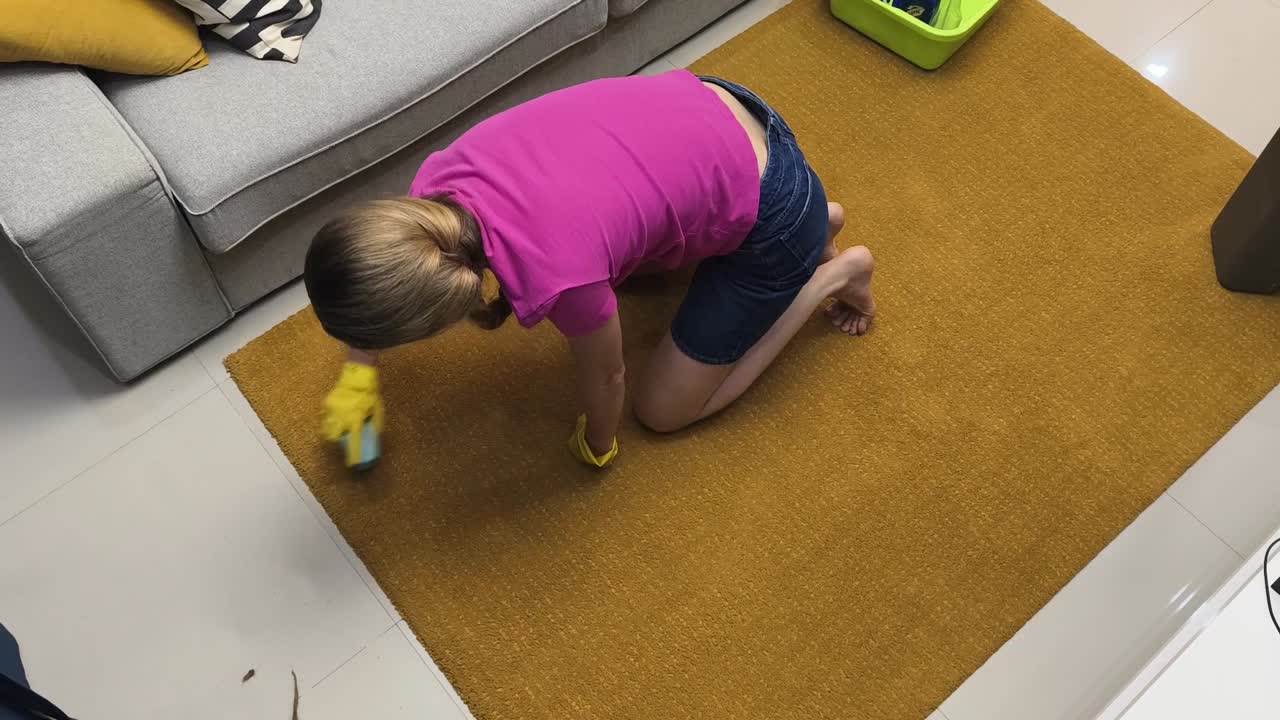 Woman cleaning a carpet