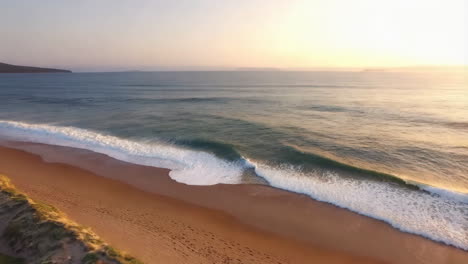 sunrise over a beach with waves