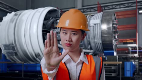 engineer gesturing stop in factory