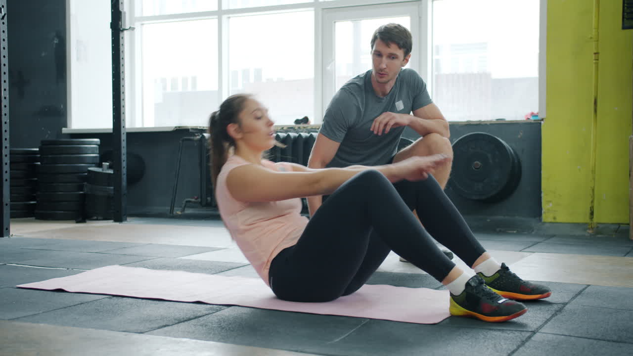 Woman Doing Crunches with Personal Trainer