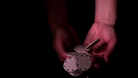 poker chips falling into hands