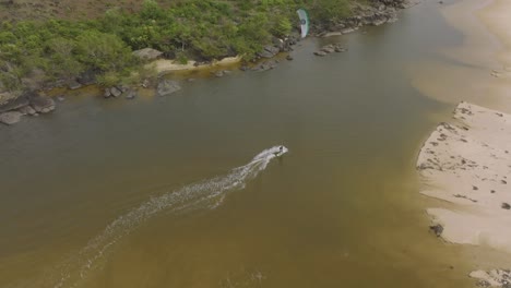 Wind-surfer-practicing-in-a-small-lake-next-the-beach-in-Sierra-Leone,-Africa