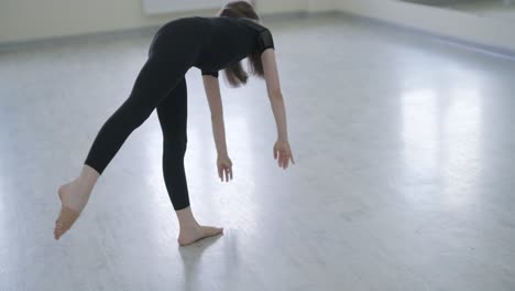 young ballet girl at studio lesson. training performance. stretching exercise pose. ballerina practice balance technique. classical elegance fitness.