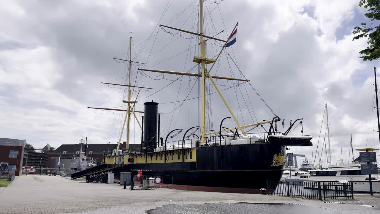 Relic of Naval Power HNLMS Schorpioen, a 19th-Century Ironclad Warship, Preserved as a Museum Ship in Den Helder, Netherlands, on a Cloudy Day