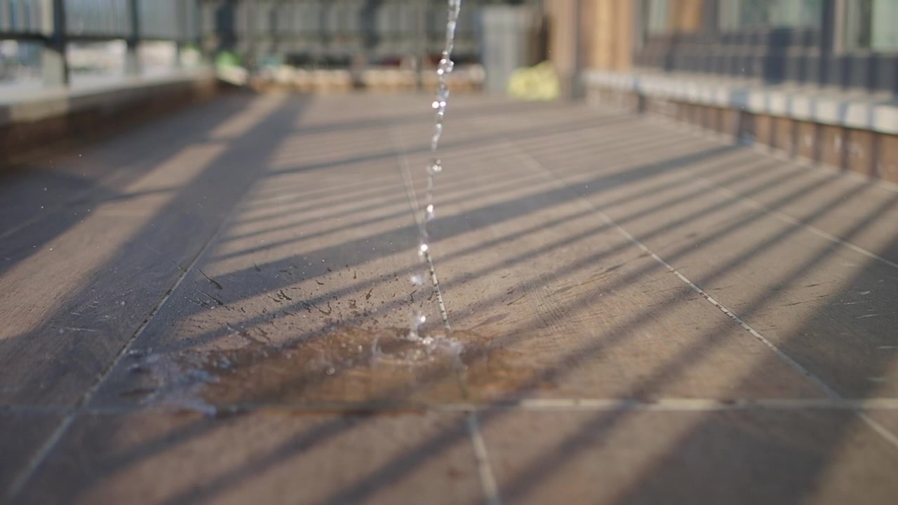 Water Pouring onto Tiled Terrace Floor