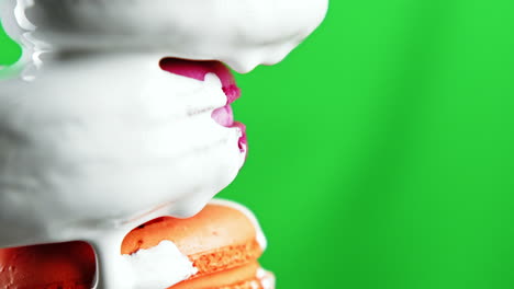 whipped cream dripping from macarons on green screen