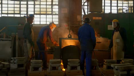 Workers-melting-metal-in-foundry-workshop-4k