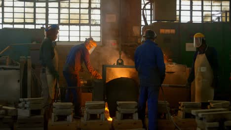 workers melting metal in foundry workshop 4k