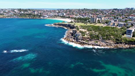 drone aerial landscape nature cliff face coastline view rocky headland gordons bay clovelly coogee beach sydney housing market suburb ocean surf nsw travel tourism australia 4k