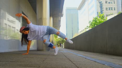 young female dancer performing dance under bridge 4k