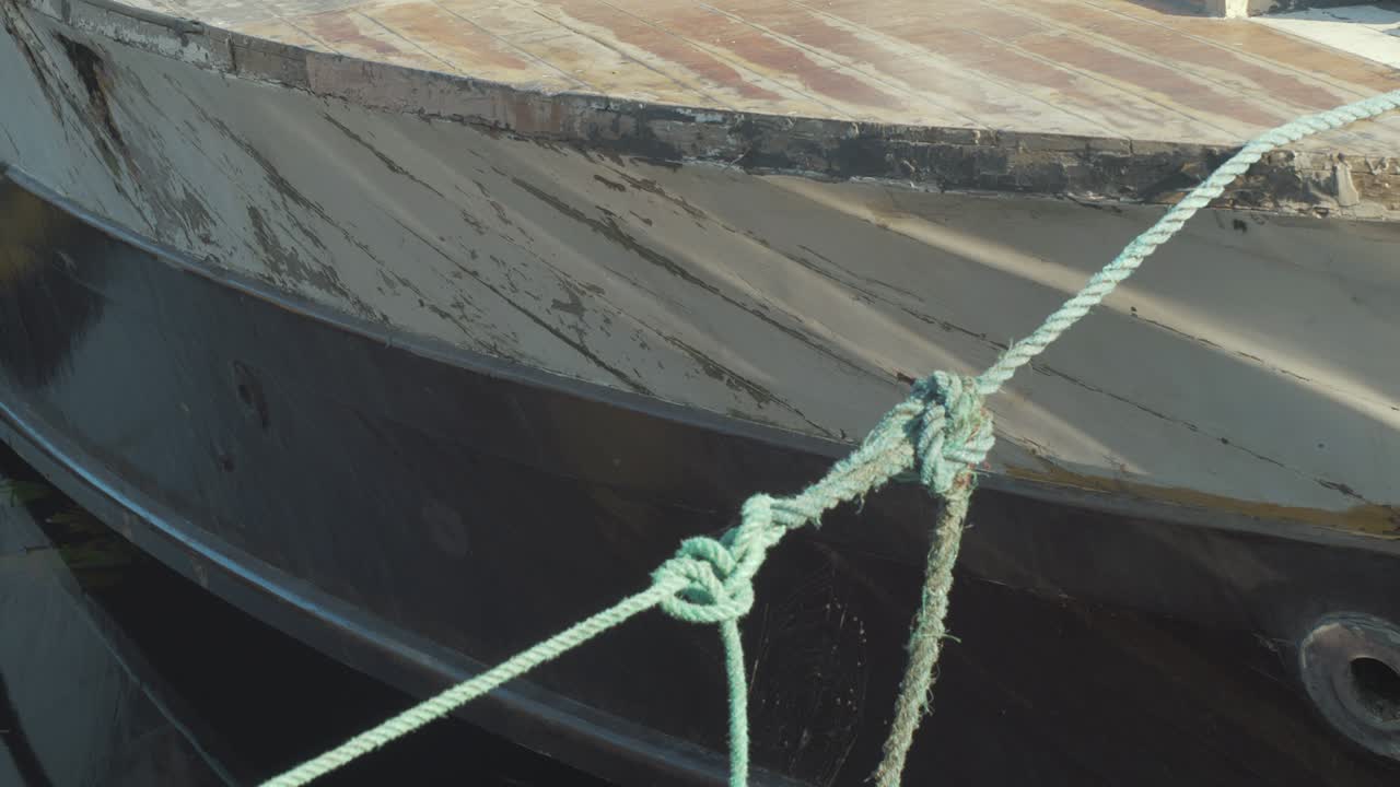 Close-up of an Old Weathered Boat Tied to a Dock