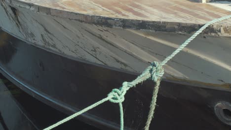 close-up of an old weathered boat tied to a dock