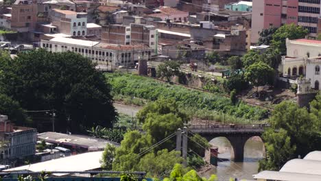 view of the river running through the capital city of honduras, tegucigalpa. latin american poverty.