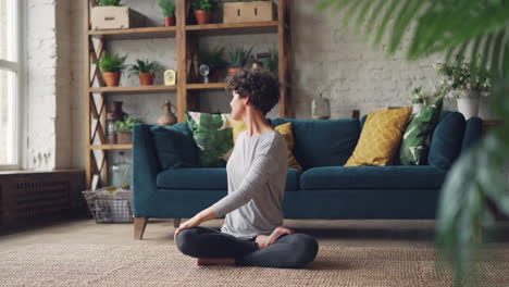 woman practicing yoga and meditation at home